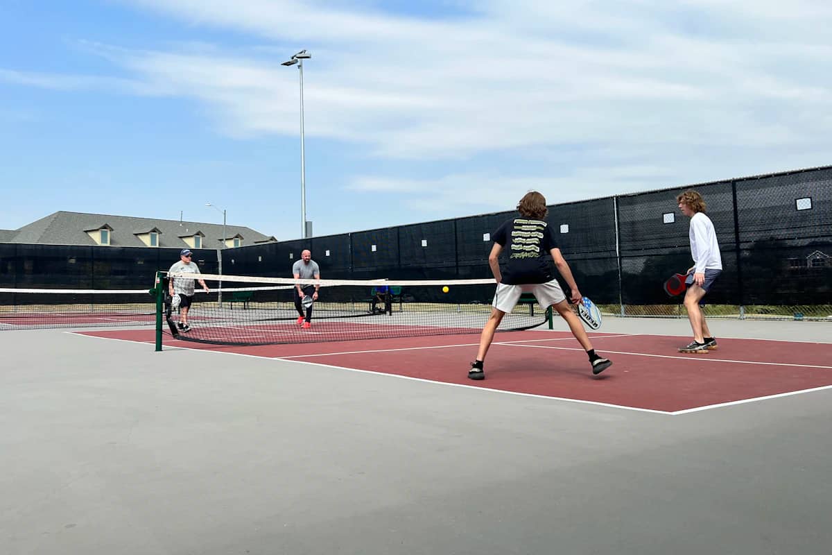 Players mid-rally on an outdoor court during a social session